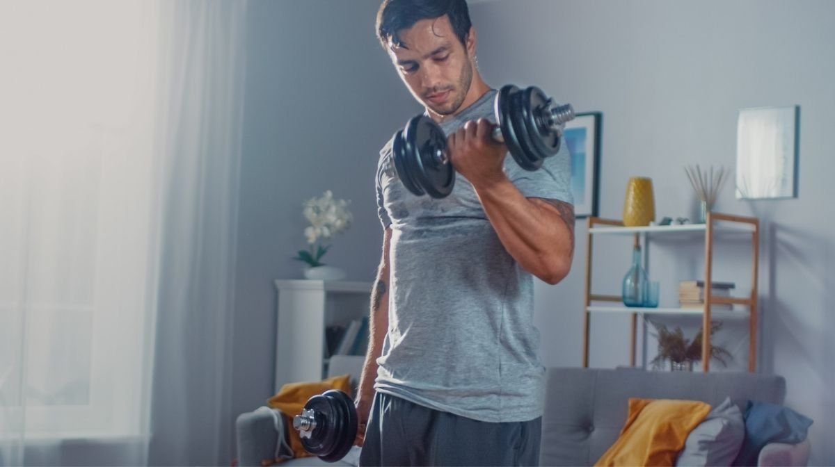 man lifting weights at home