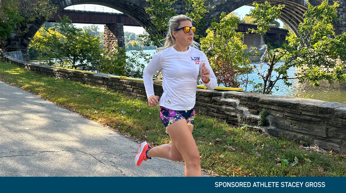 female athlete in white t-shirt and shorts running outdoor