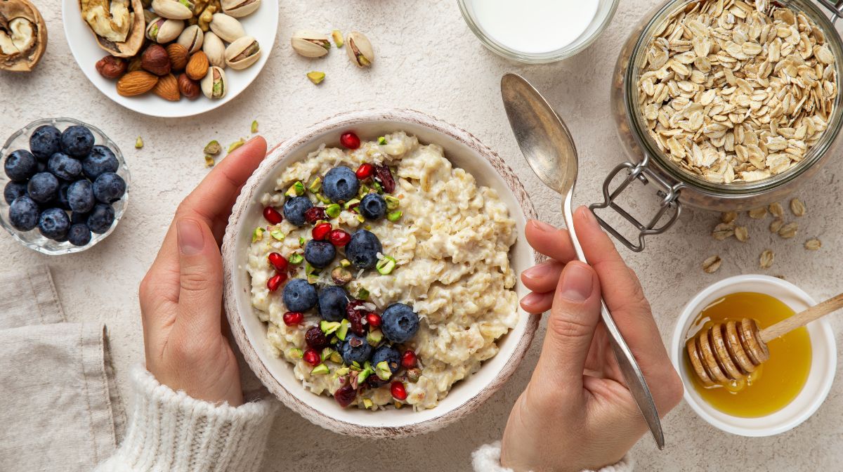 A bowl of high-protein oatmeal topped with fruit and nuts.