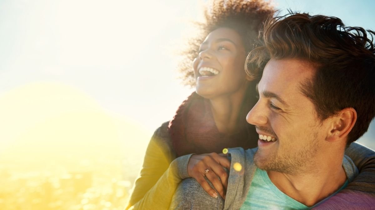 happy, healthy young couple enjoying natural sunlight