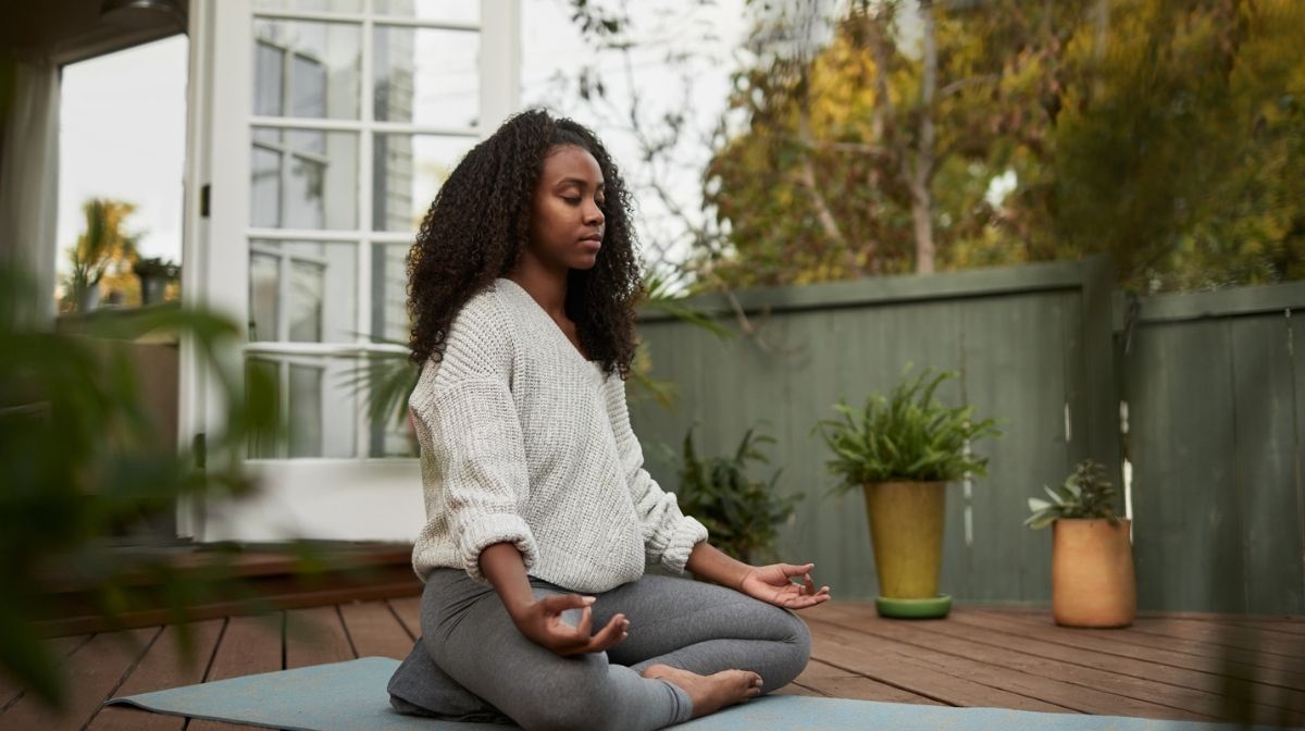 woman practising yoga for mindfulness at home