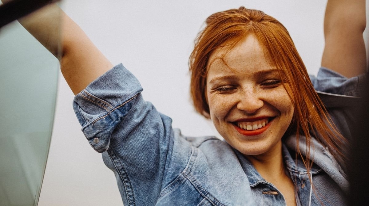 happy woman with red hair and freckles