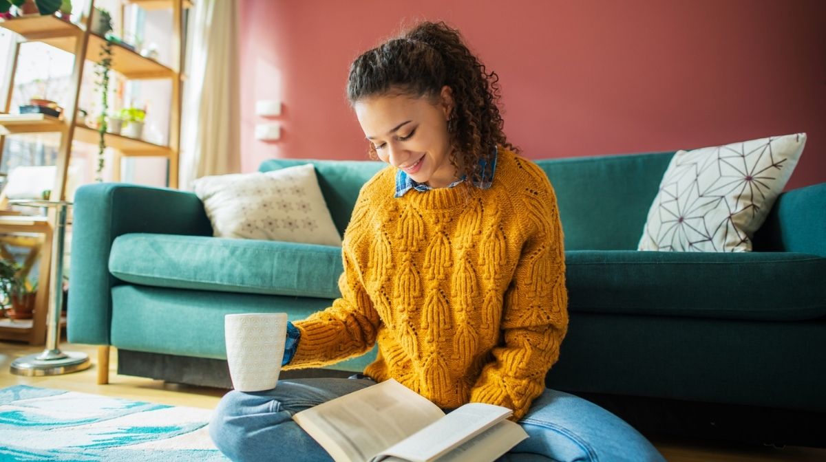 woman reading with a hot drink