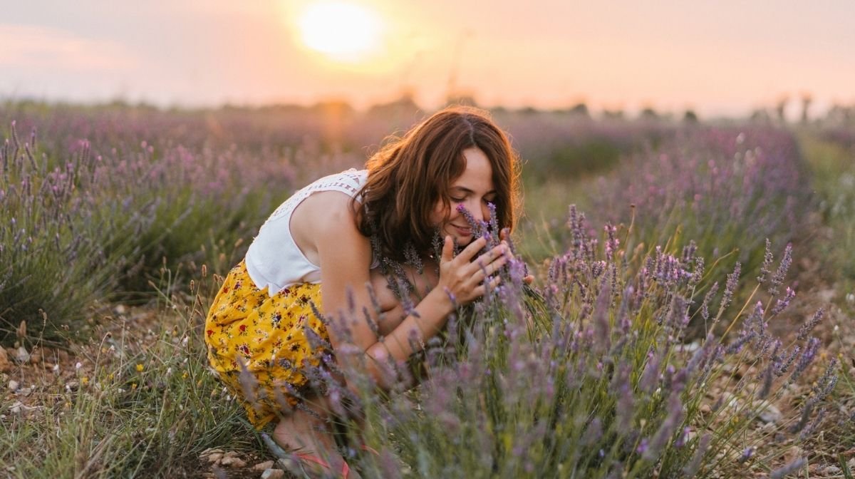 woman smelling lavender in a field