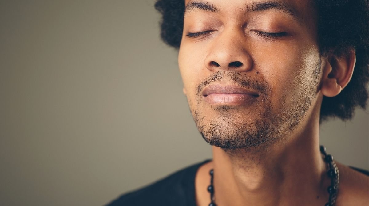 man meditating with eyes closed