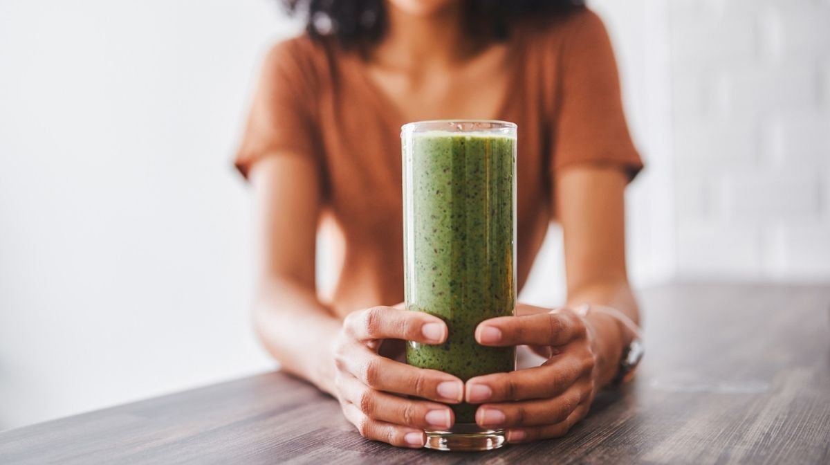 woman drinking green smoothie