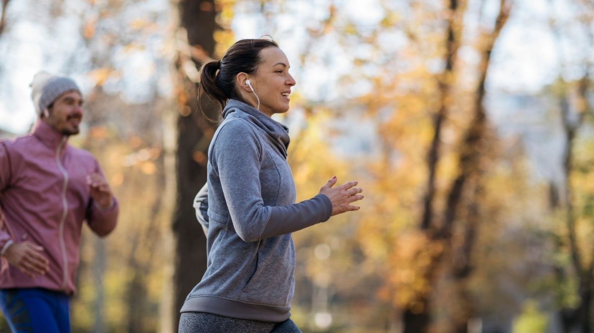 man and woman jogging in park