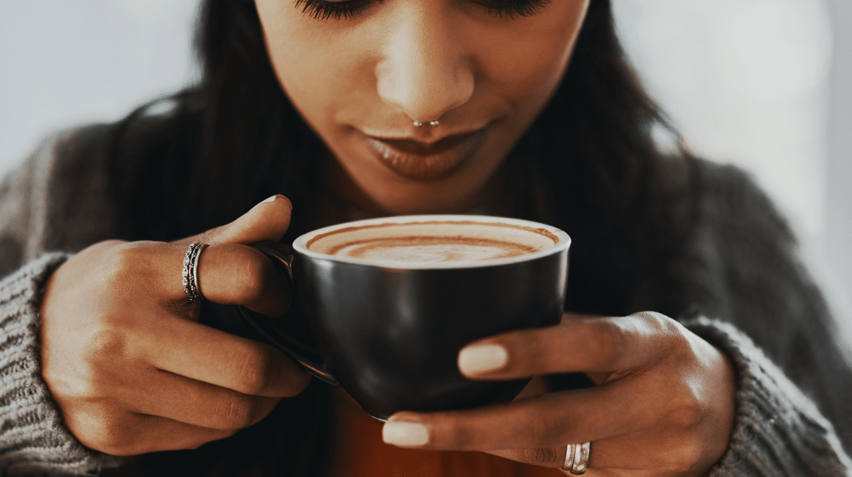 Lady holding a cup of coffee