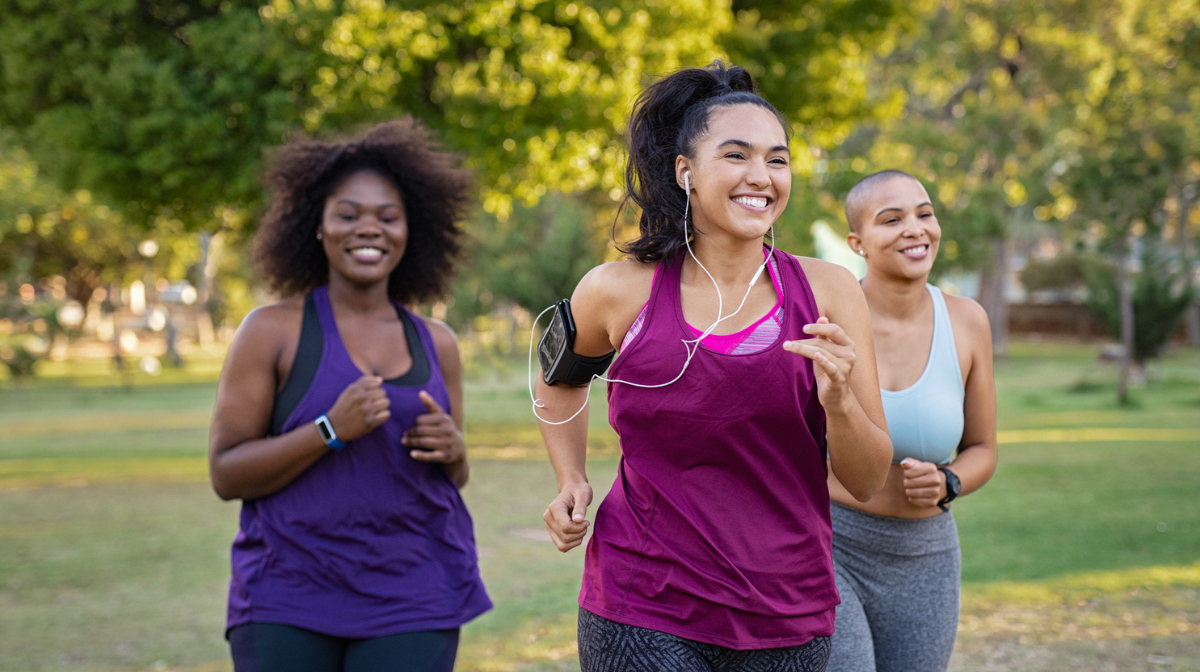 Three women jog happily