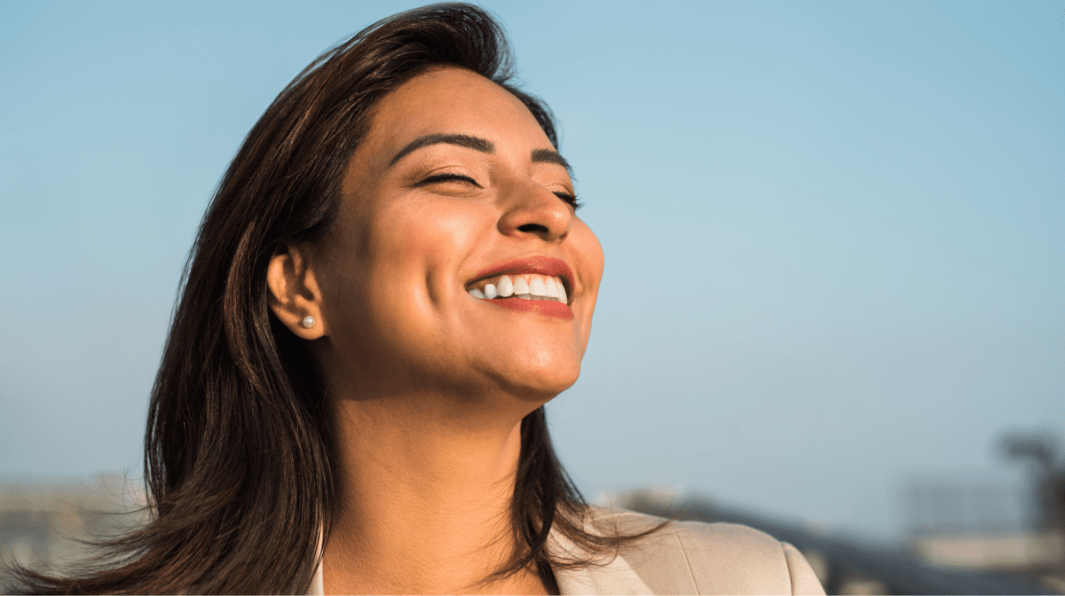 Woman Smiles Happily Relaxed With Her Eyes Closed