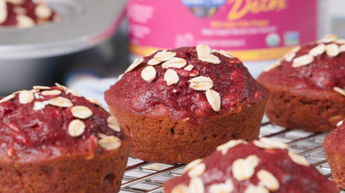 Beetroot muffins topped with oats cooling on a wire rack