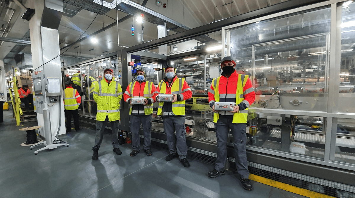 4 men in the Coca-Cola Sidcup factory, where we have kicked off the first production of our new Shrink to Board packs
