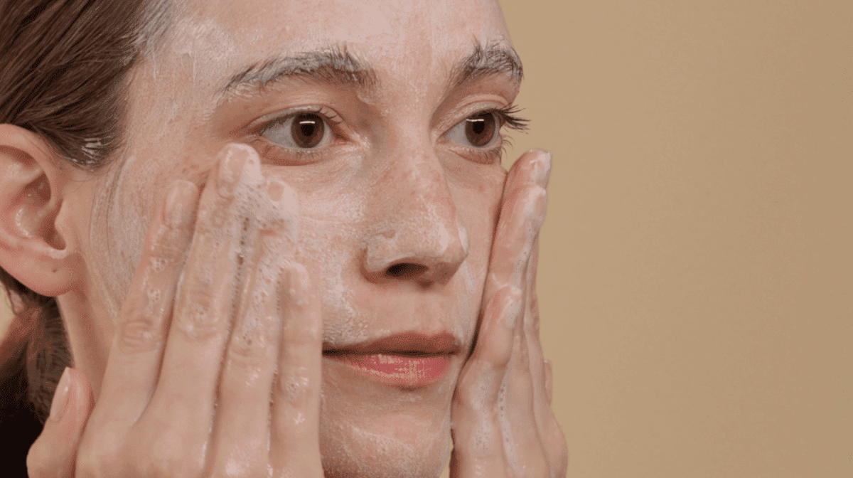 Women deep cleansing her face with a foaming cleanser