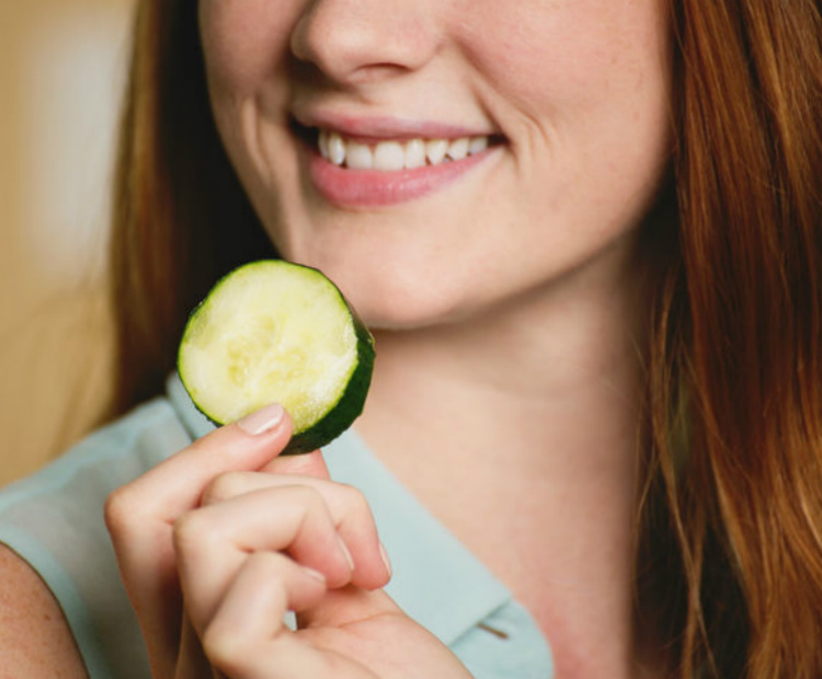Woman holding cucumber