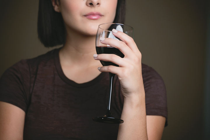 woman drinking a glass of red wine