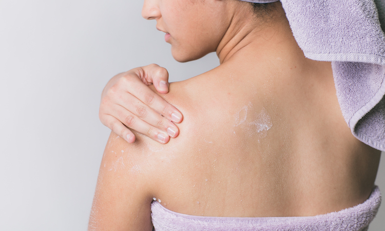 Woman Wrapped with Bath Towels, Applying Cream on her Face Stock