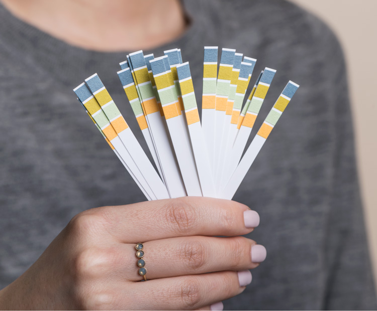 Girl holding litmus pH test strips 2