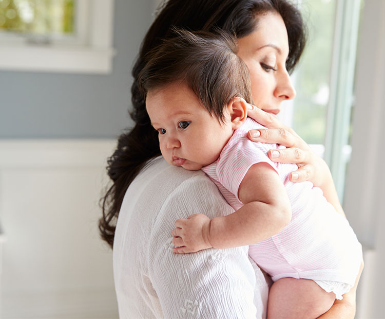 Mother-holding-a-baby-at-home-1 | Dermstore Blog