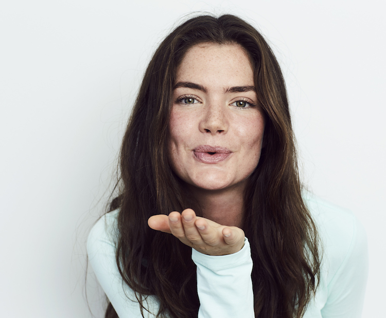 girl blowing a kiss to camera