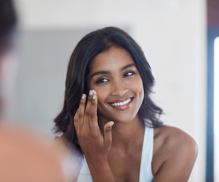 woman applying eye cream