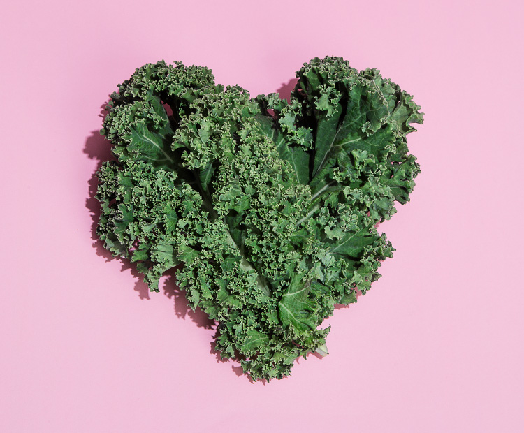 Heart shaped kale on pink background -1 | Dermstore Blog