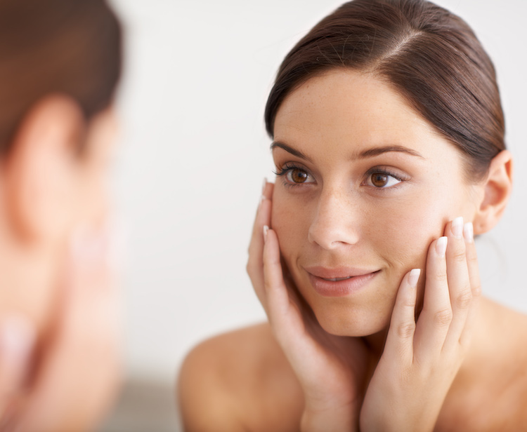 young woman looking in mirror