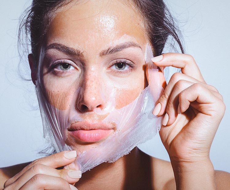 woman removing peel off facial mask