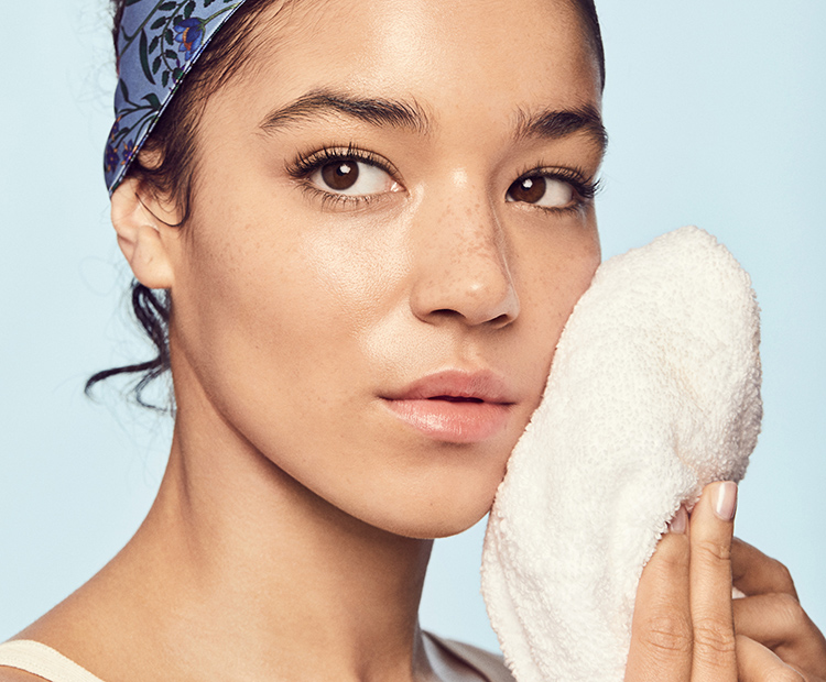 Woman drying face with a towel 1