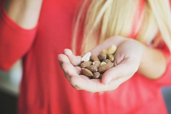 woman with a handful of almonds