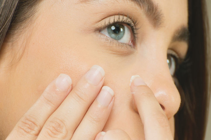 woman applying acne treatment