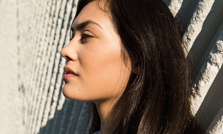 Woman with clear skin standing in the sunlight