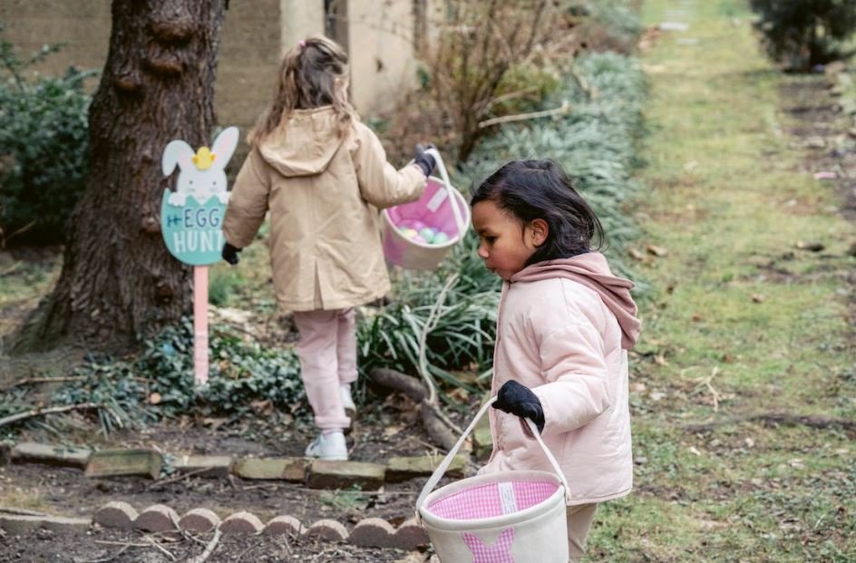 Two young girls on an Easter egg hunt