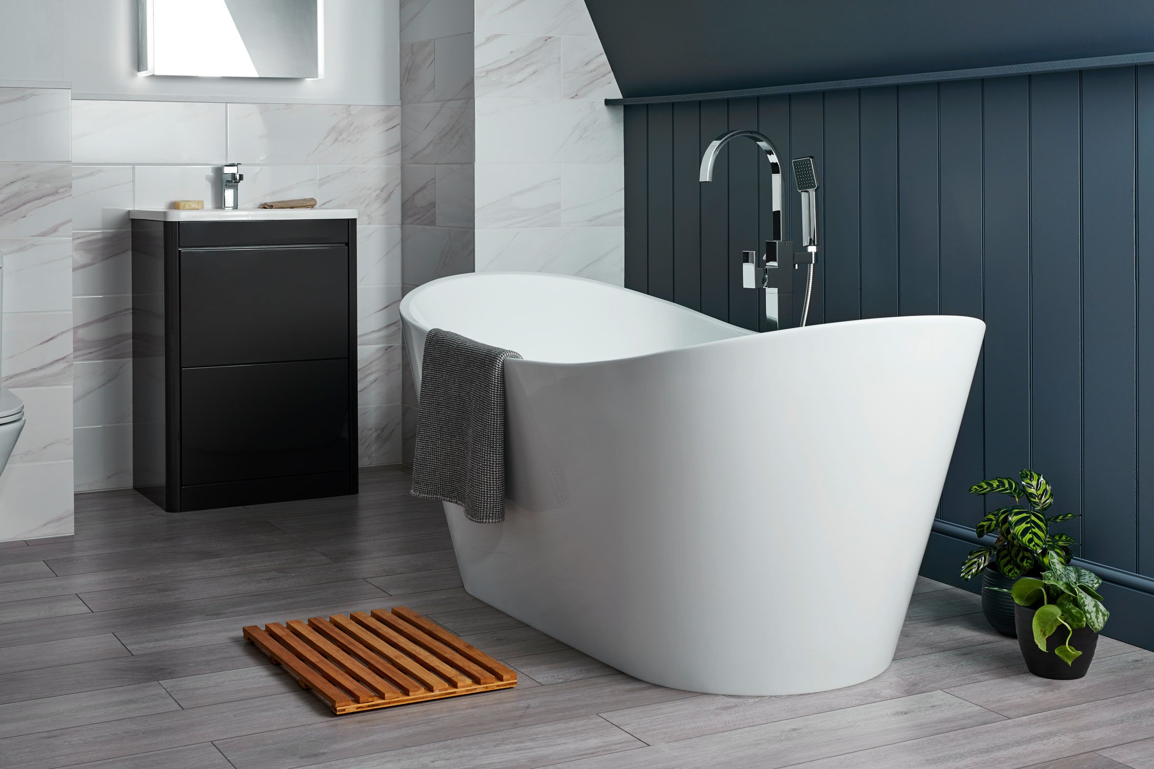 an image of a freestanding bath against a blue wall