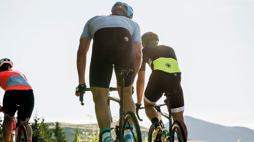 3 cyclists going up a mountain