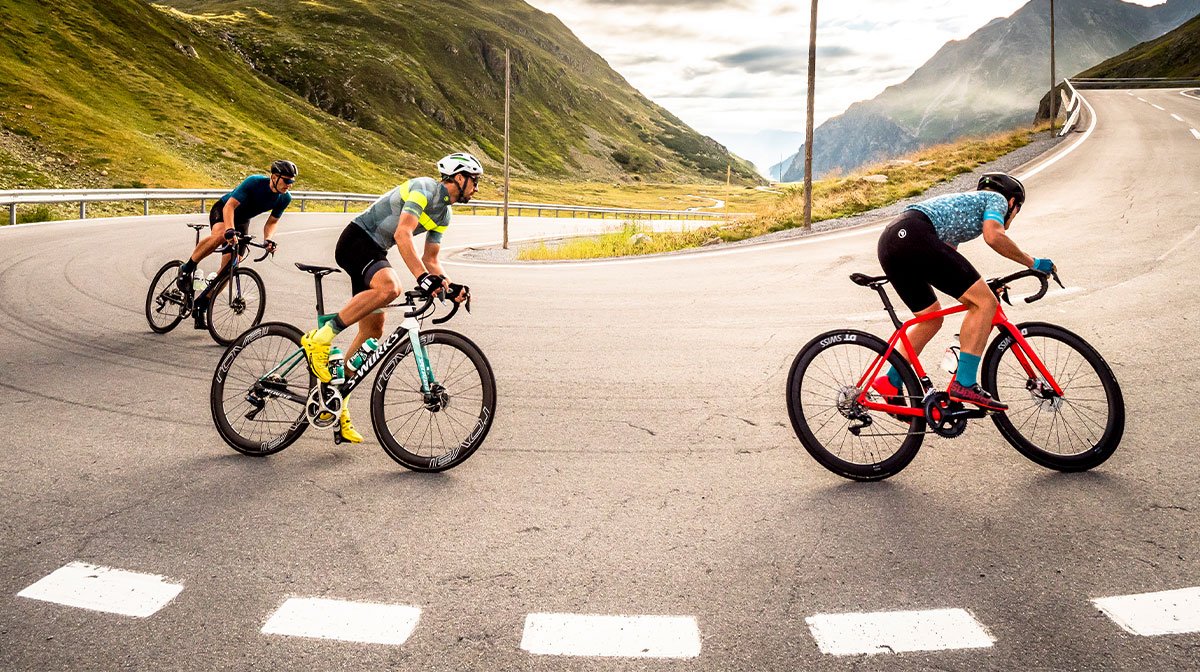 Trio of cyclists take corner at pace