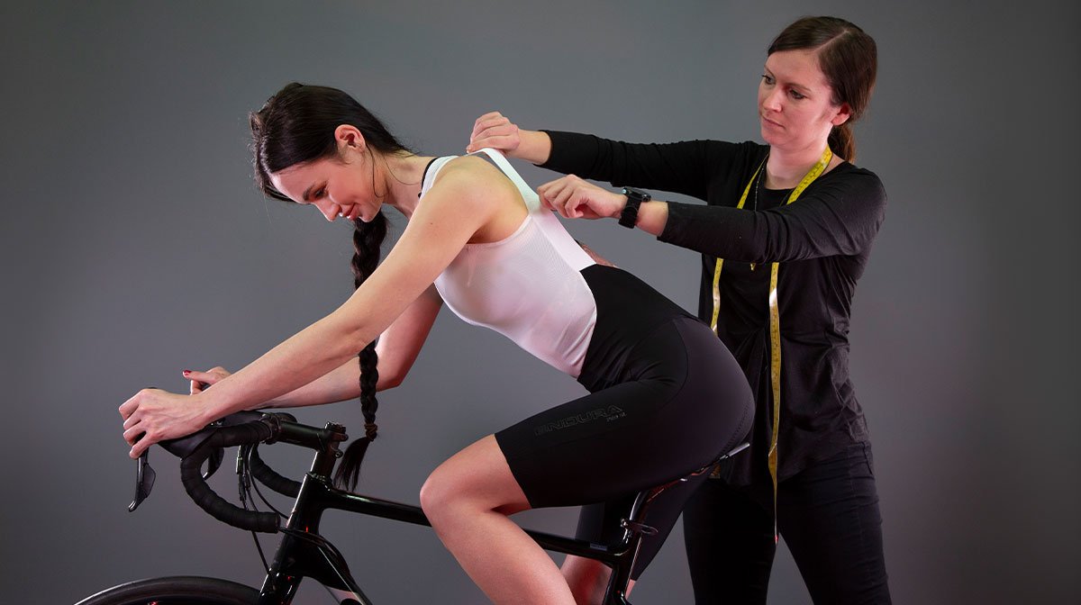 Person measures back of cyclist