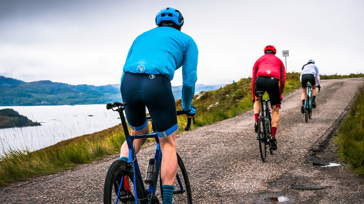 Trio of cyclists ascend hill