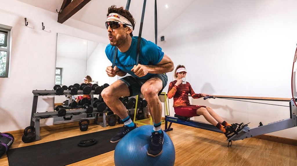 Man balances on top of exercise ball