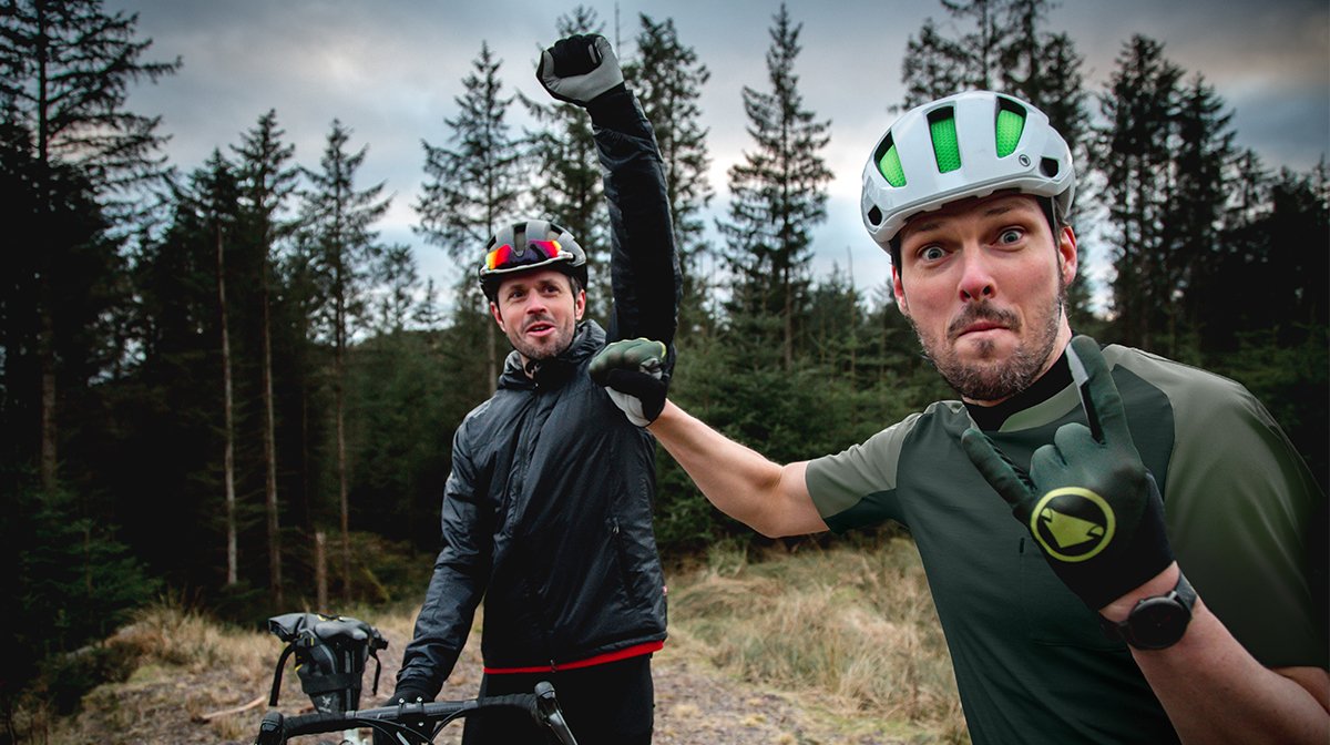 Cyclists fistbump, dressed in Endura from head to toe