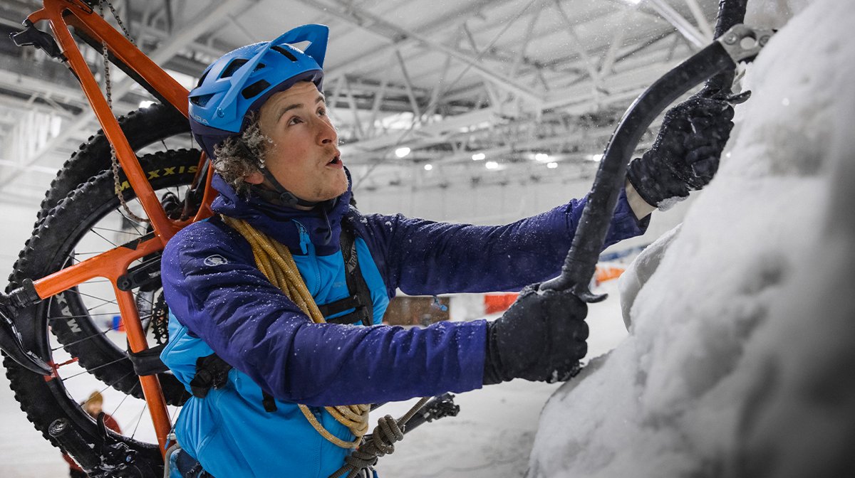 Woman climbs snow in blue Endura waterproof