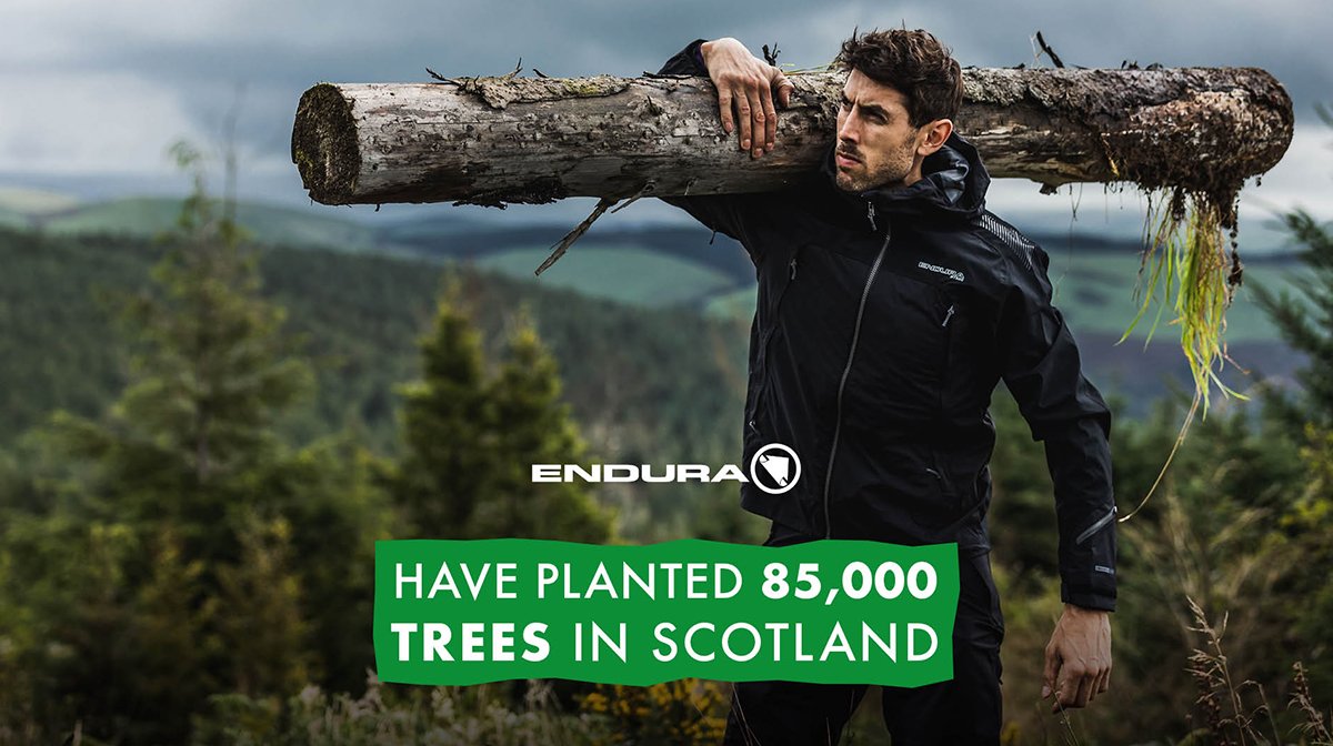 Man holds tree on shoulder in Endura sustainability promotion