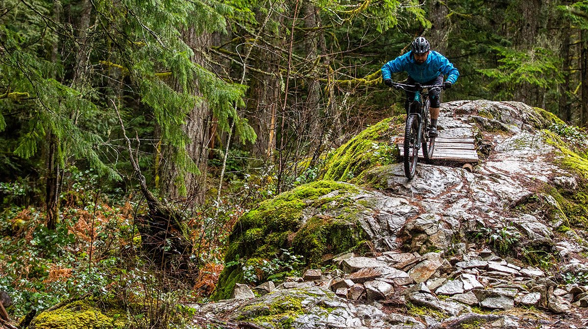 Tom Bradshaw rides along path in Endura waterproof gear