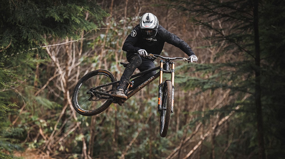 Endura rider jumps on bike while wearing Endura MTB shoes