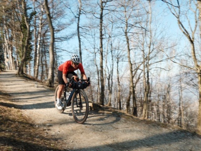 Rider heads down gravel hill in full Endura gear