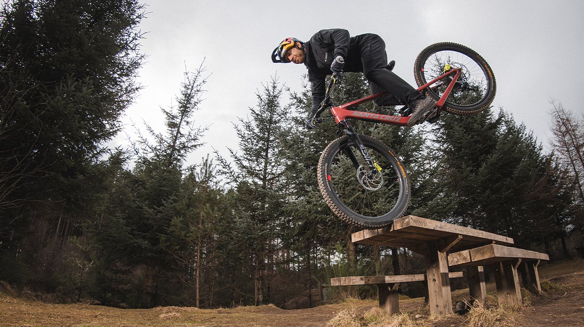 Man jumps over ramp in full Endura gear