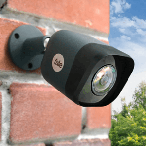 a close up image of a CCTV camera on a brick wall 