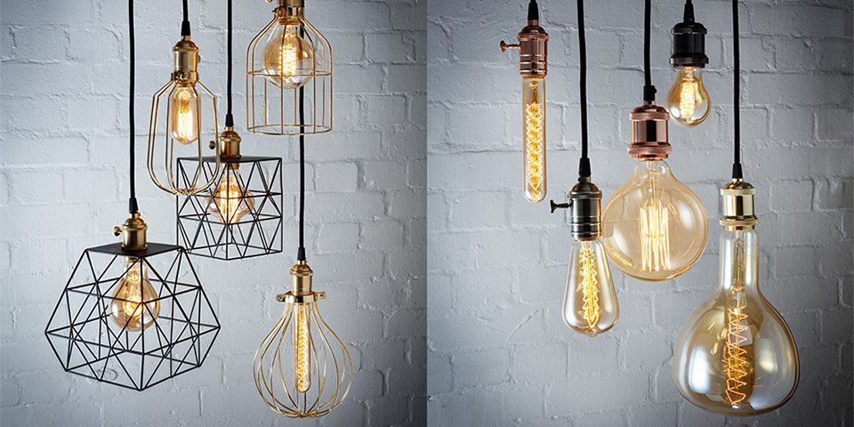 10 low hanging light bulbs in various shapes and sizes in a white, bricked room.