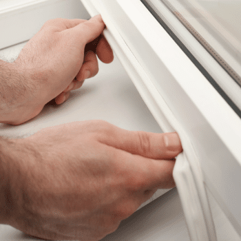 an image of a person securing draught excluder