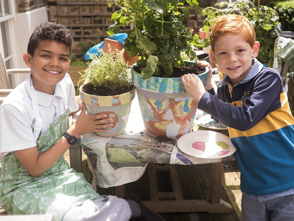 Kids painting plant pots