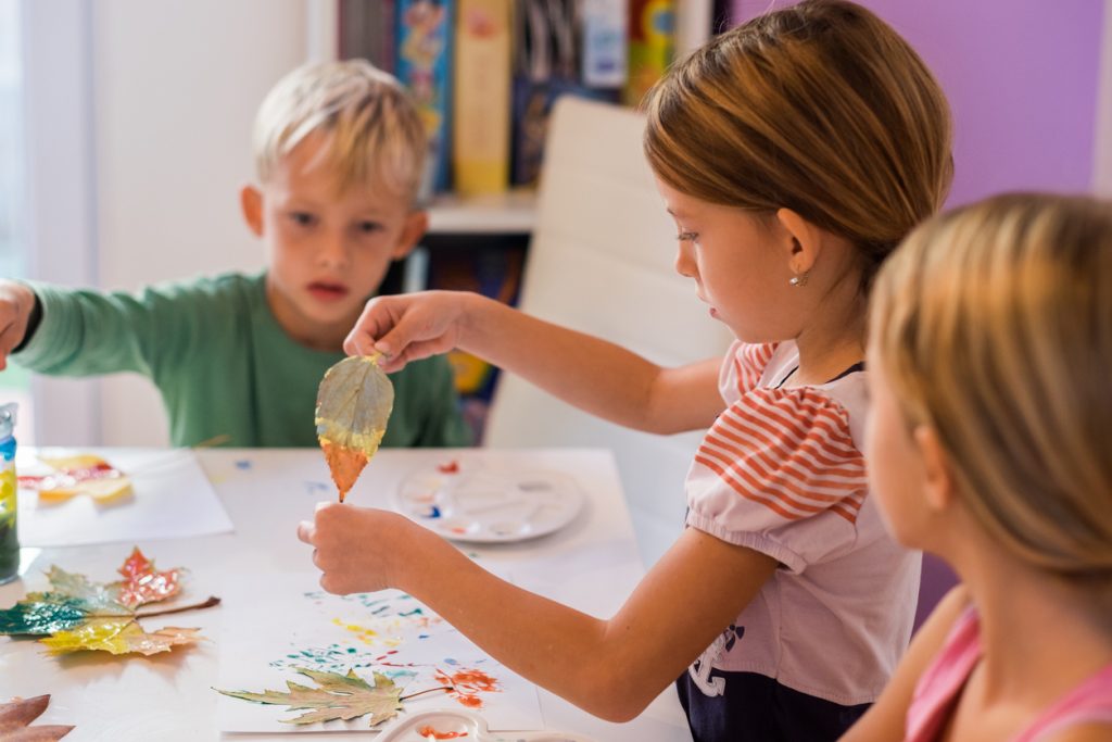 children painting leaves